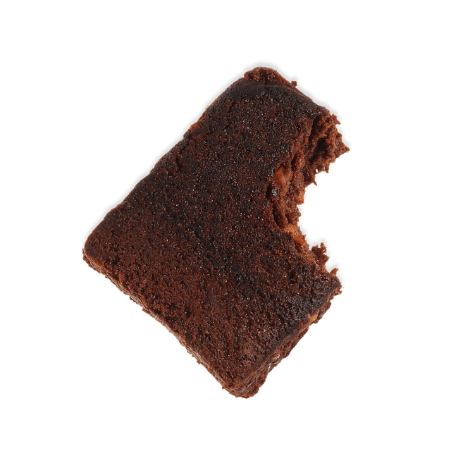 A slice of chocolate cake with a bite taken out of it, against a plain green background.